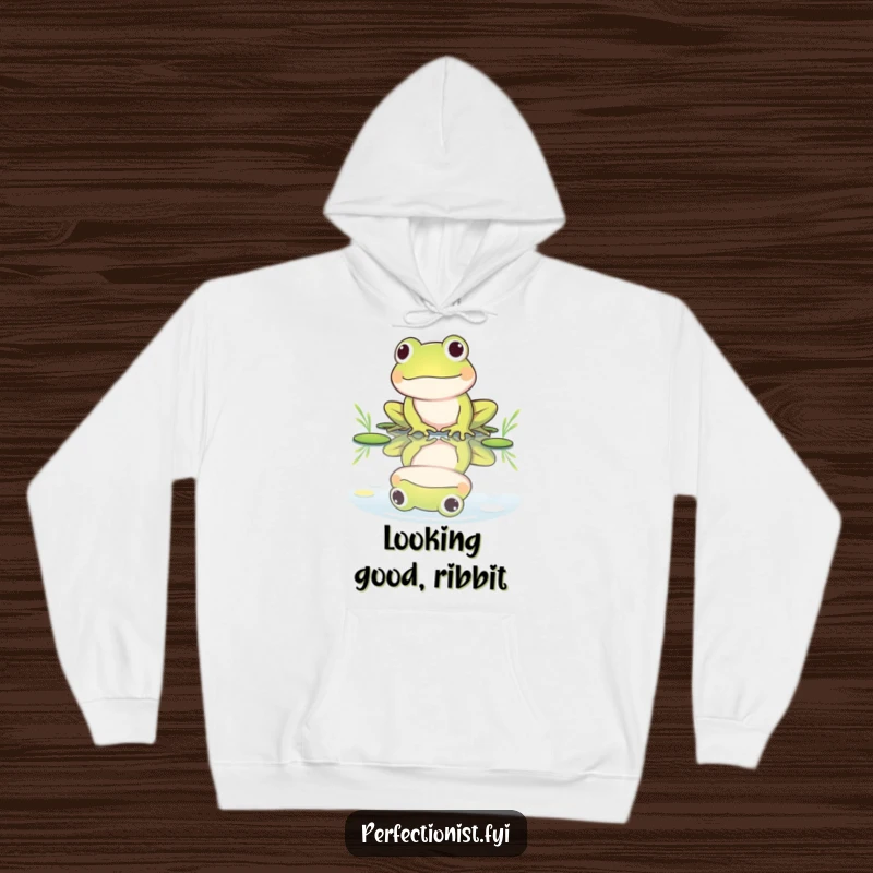 Funny hoodie depicting a frog character polishing its reflection in a still pond, perfect for expressing a love for self-care and humor.