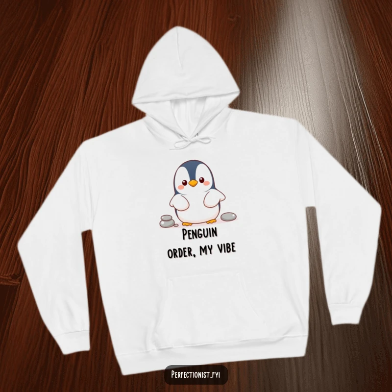 Funny penguin hoodie with a cheerful penguin character lining up pebbles, a comfortable and humorous gift for organizers.