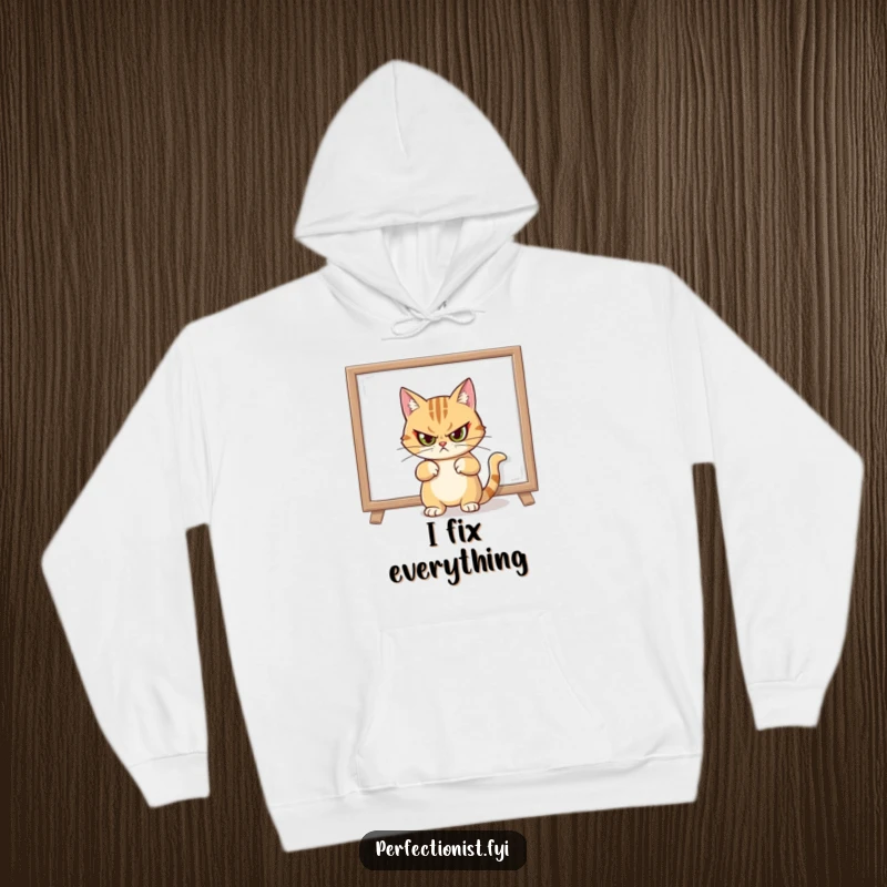 Funny hoodie depicting a cat with a stern expression after straightening a crooked painting, embodying high decor standards.