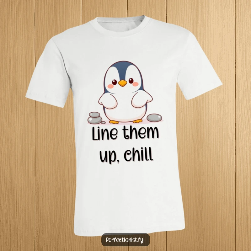 Funny penguin t-shirt showing a cheerful penguin character organizing pebbles in a line, ideal for orderly people.